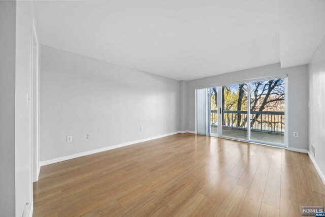 spare room with light hardwood / wood-style flooring