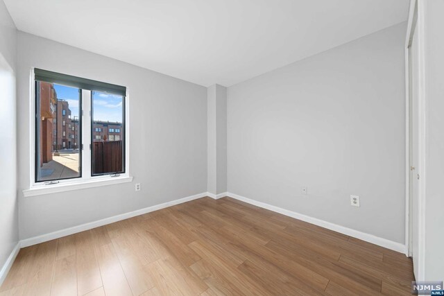 empty room with wood-type flooring