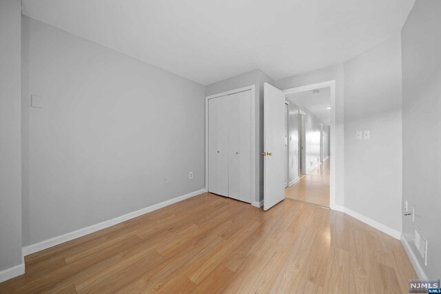 interior space featuring a closet and light hardwood / wood-style floors