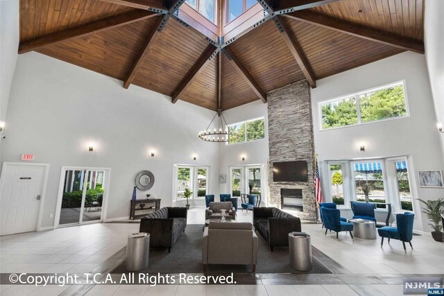 living room featuring high vaulted ceiling, a wealth of natural light, and wood ceiling