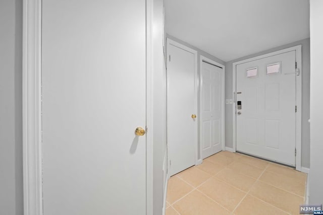 entryway with light tile patterned floors