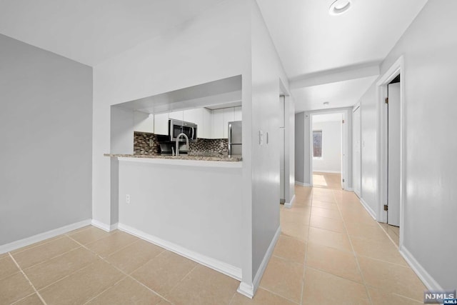 corridor featuring light tile patterned floors