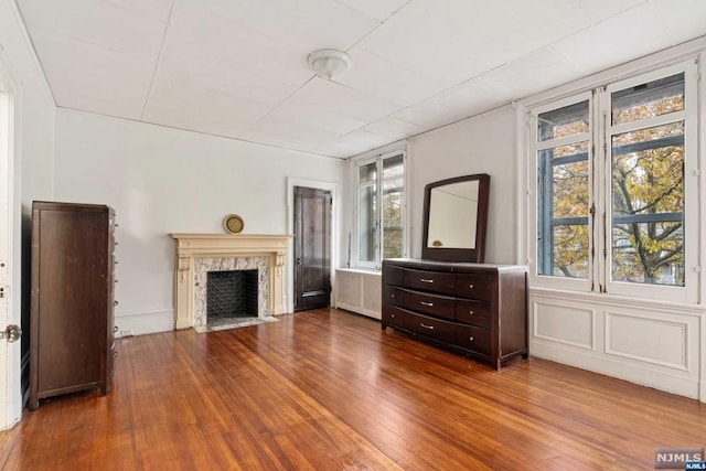 interior space with a high end fireplace and wood-type flooring