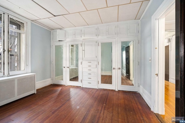 interior space with radiator heating unit and french doors