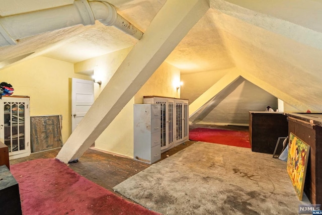 additional living space featuring vaulted ceiling