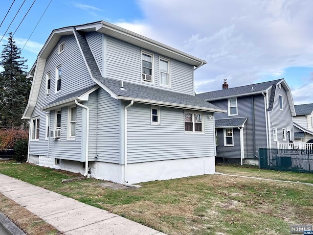 exterior space with cooling unit and a front lawn