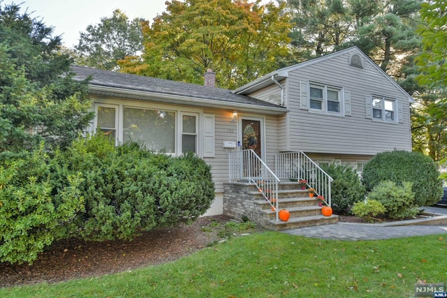 split level home featuring a front lawn