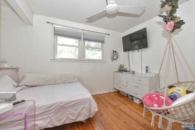 bedroom with ceiling fan and light wood-type flooring