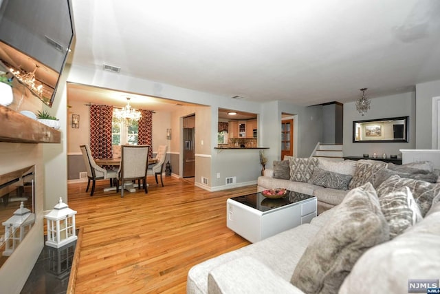 living room featuring a chandelier and hardwood / wood-style flooring