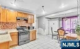 kitchen with black range oven and backsplash