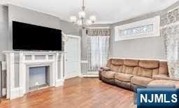 living room featuring wood-type flooring and a chandelier