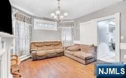 living room with hardwood / wood-style flooring and an inviting chandelier