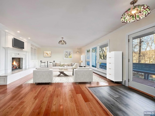 unfurnished living room featuring crown molding, plenty of natural light, and hardwood / wood-style flooring