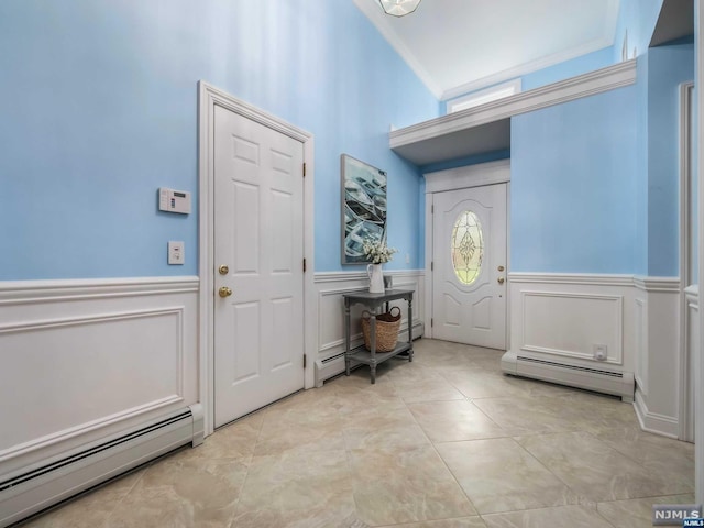 entryway featuring ornamental molding and a baseboard heating unit