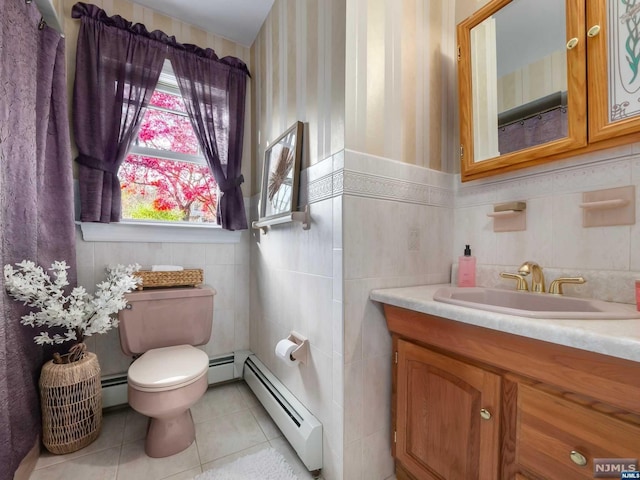 bathroom with vanity, a baseboard radiator, and tile walls