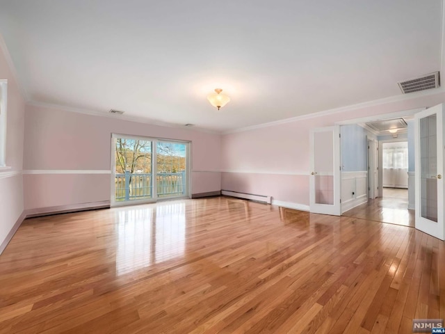 unfurnished room featuring light hardwood / wood-style floors, crown molding, a baseboard heating unit, and french doors