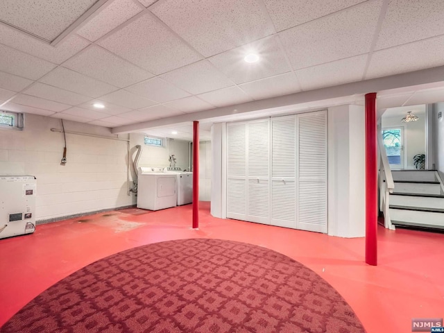 basement featuring a drop ceiling and independent washer and dryer