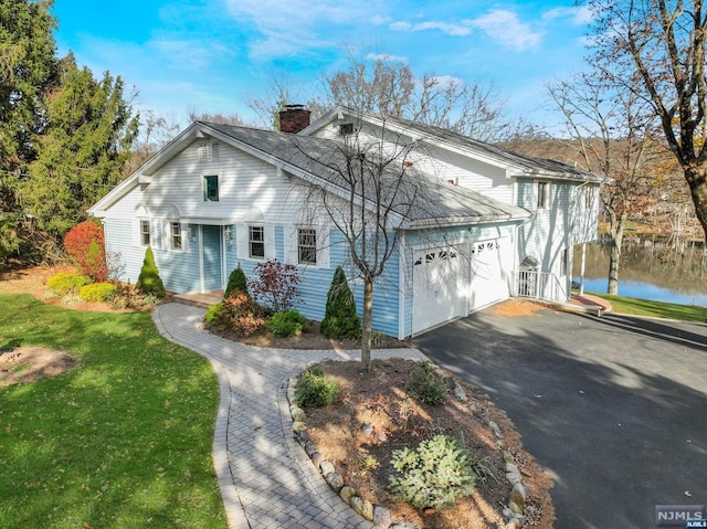 view of front of house featuring a water view and a garage