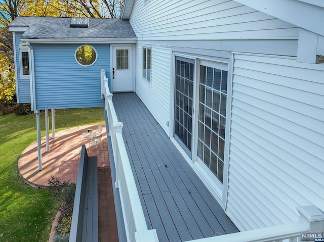 wooden deck with a lawn