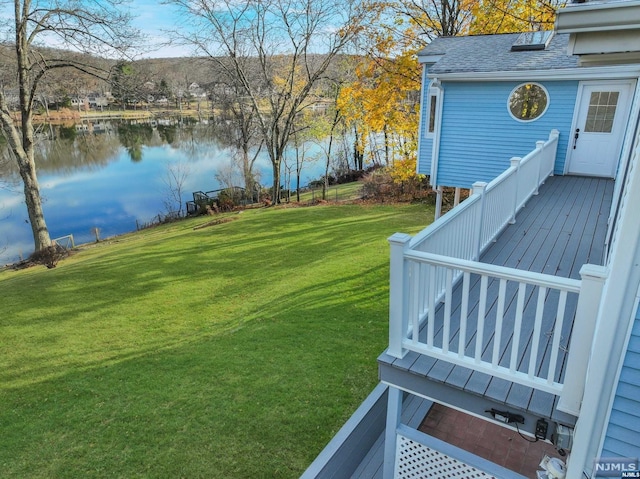 view of yard featuring a deck with water view