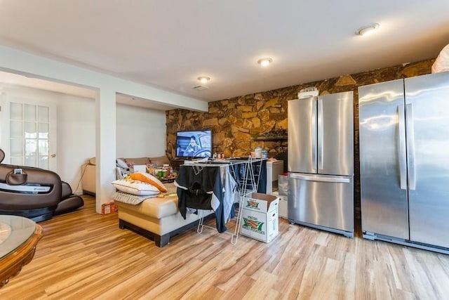 kitchen featuring stainless steel refrigerator and light hardwood / wood-style flooring