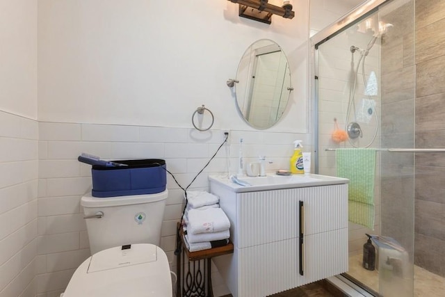 bathroom featuring toilet, tile walls, and a shower with shower door