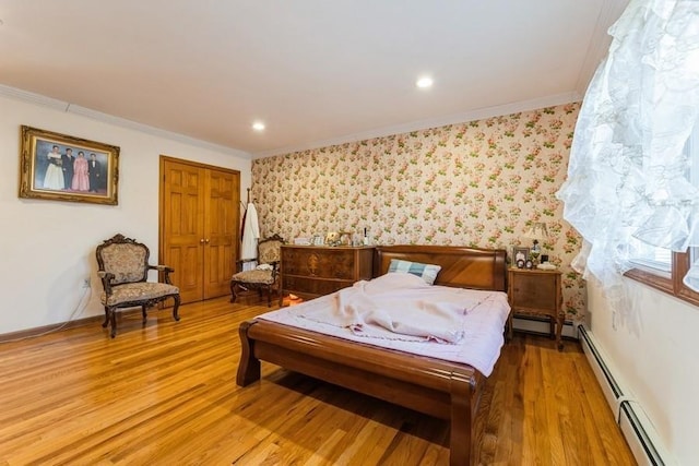 bedroom with wood-type flooring, a baseboard radiator, and ornamental molding