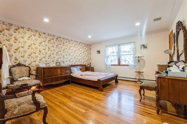 bedroom with crown molding, a baseboard radiator, and light wood-type flooring