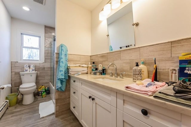 bathroom featuring vanity, a baseboard heating unit, wood-type flooring, tile walls, and toilet