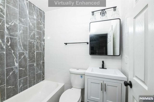 full bathroom featuring toilet, shower / washtub combination, vanity, and tile walls