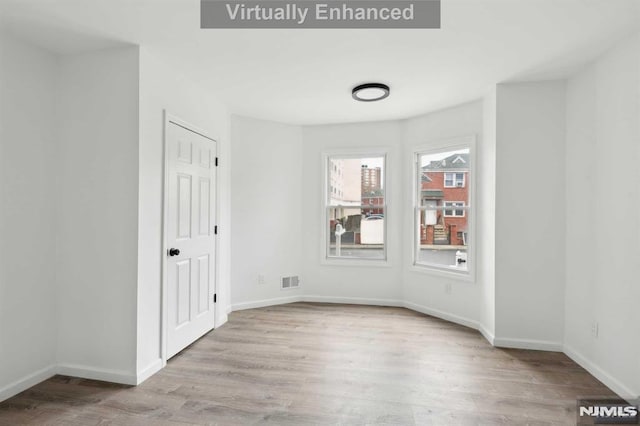 unfurnished room with light hardwood / wood-style floors