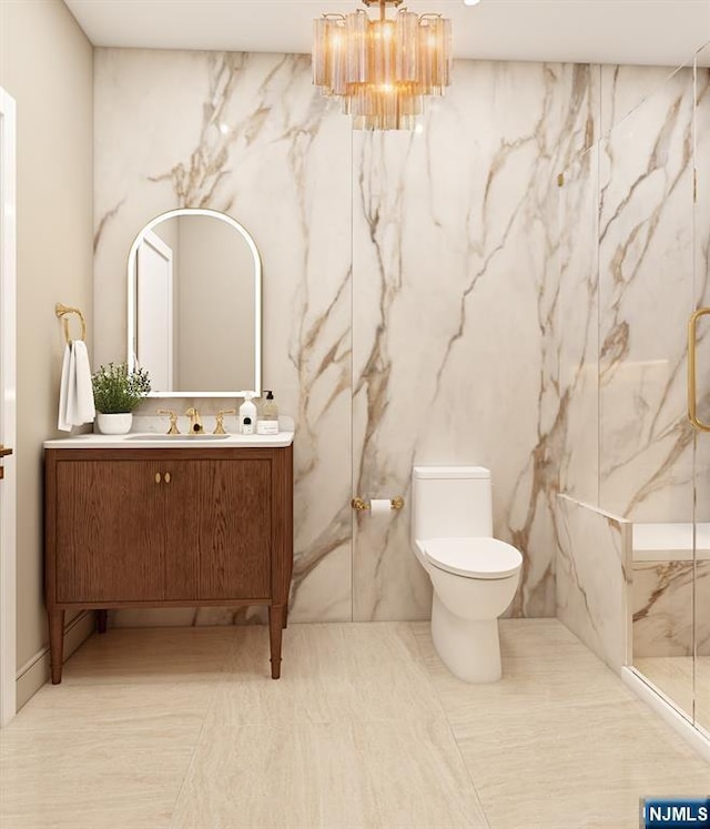 bathroom with vanity, toilet, and a chandelier