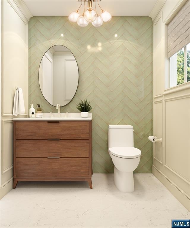 bathroom featuring vanity, a chandelier, and toilet