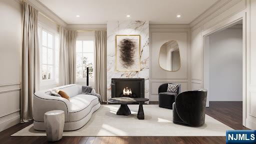 sitting room featuring dark hardwood / wood-style floors, ornamental molding, and a premium fireplace