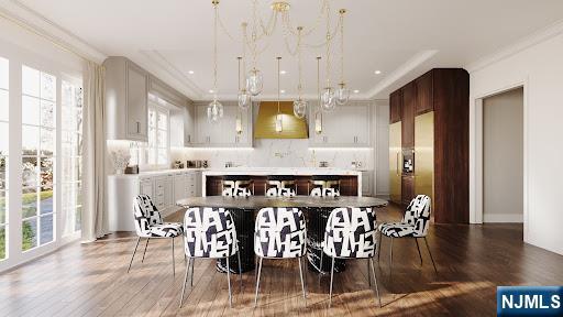 kitchen featuring ventilation hood, crown molding, dark wood-type flooring, and decorative backsplash