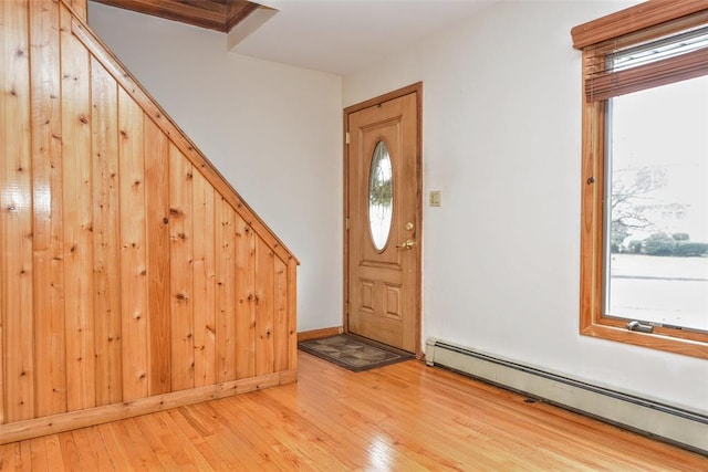 entryway with light hardwood / wood-style flooring and a baseboard radiator