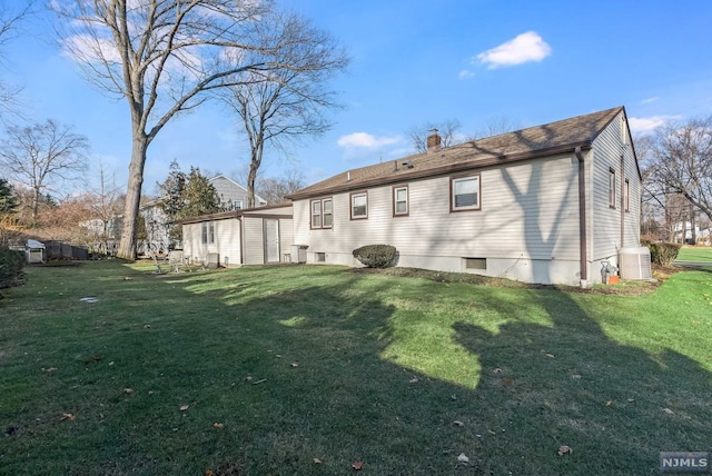 rear view of property with a lawn