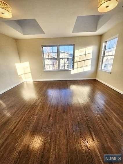 unfurnished living room featuring dark hardwood / wood-style floors