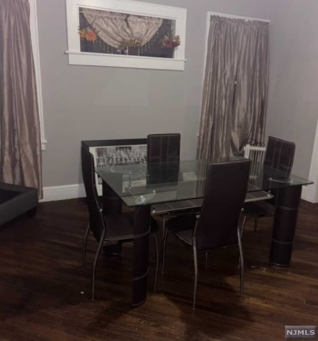 dining room with dark wood-type flooring