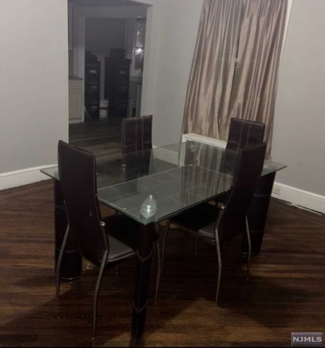 dining room with dark hardwood / wood-style floors