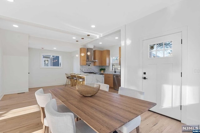 dining room with light hardwood / wood-style flooring and sink