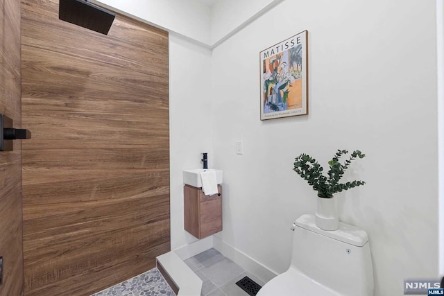 bathroom featuring tile patterned floors, vanity, and toilet