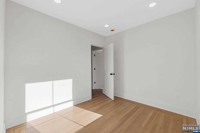 empty room with hardwood / wood-style floors