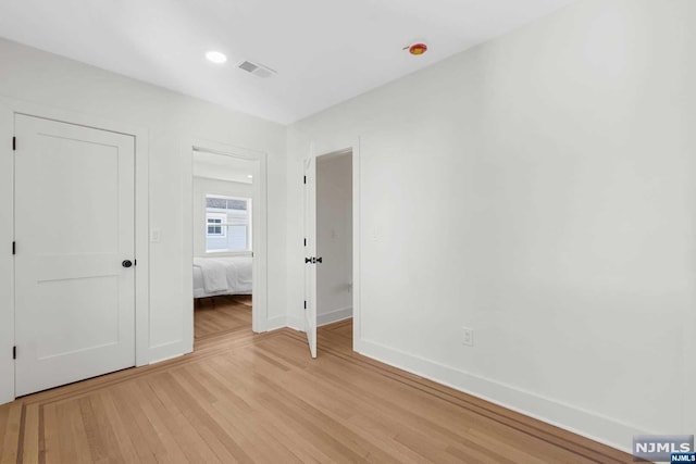 unfurnished bedroom with light wood-type flooring