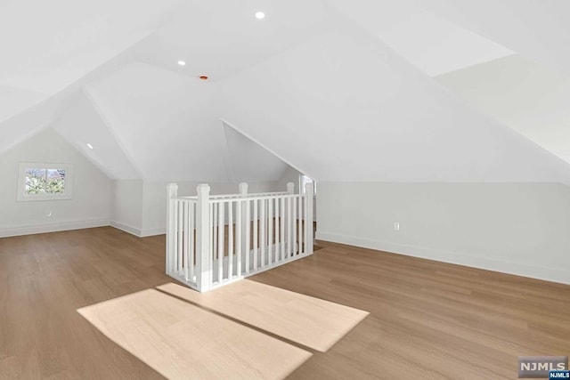 bonus room featuring light hardwood / wood-style flooring and lofted ceiling