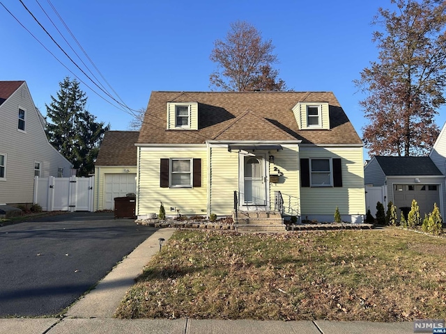 view of front of house with a garage and a front yard