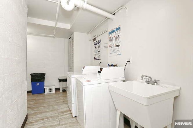 laundry area featuring washer and dryer and sink