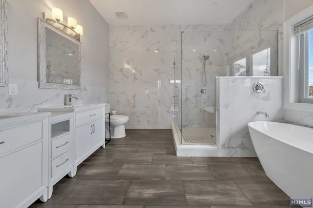 full bathroom with separate shower and tub, vanity, tile walls, and toilet