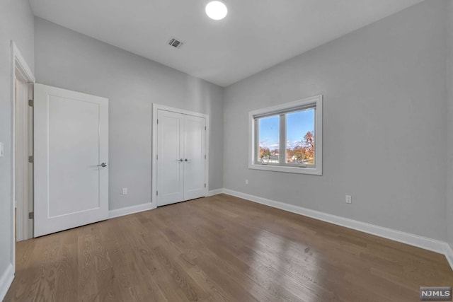 unfurnished bedroom with wood-type flooring