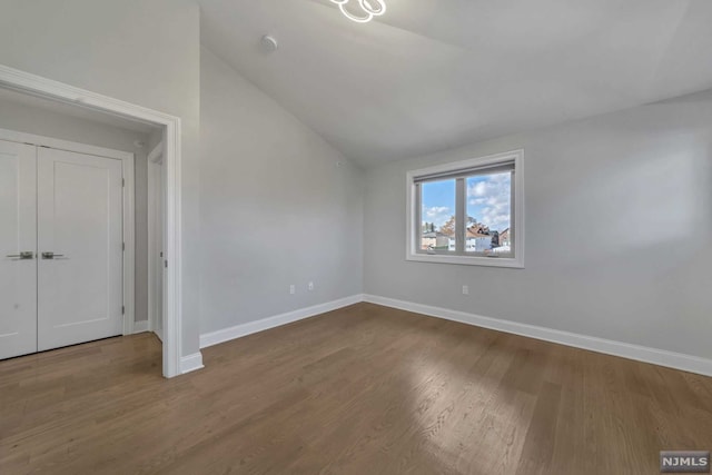 interior space with hardwood / wood-style floors and lofted ceiling